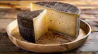 Manchego on a wooden plate with a rustic background