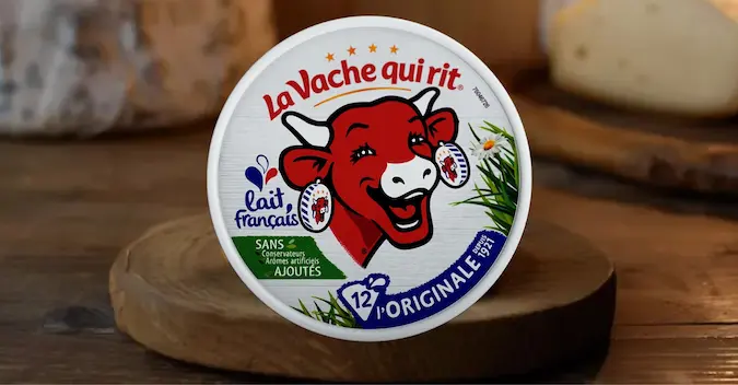La Vache Qui Rit on a wooden plate with a rustic background